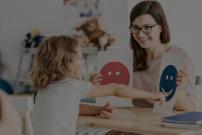 A teacher and child learning about happy and sad